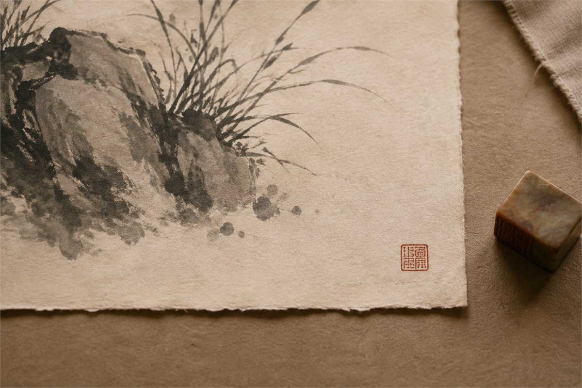 Small red corner seal impression balancing the blank lower area of an ink painting