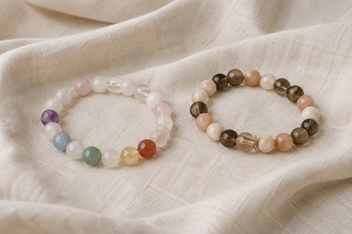 Two complete bead bracelets, one muted rainbow and one in earth tones