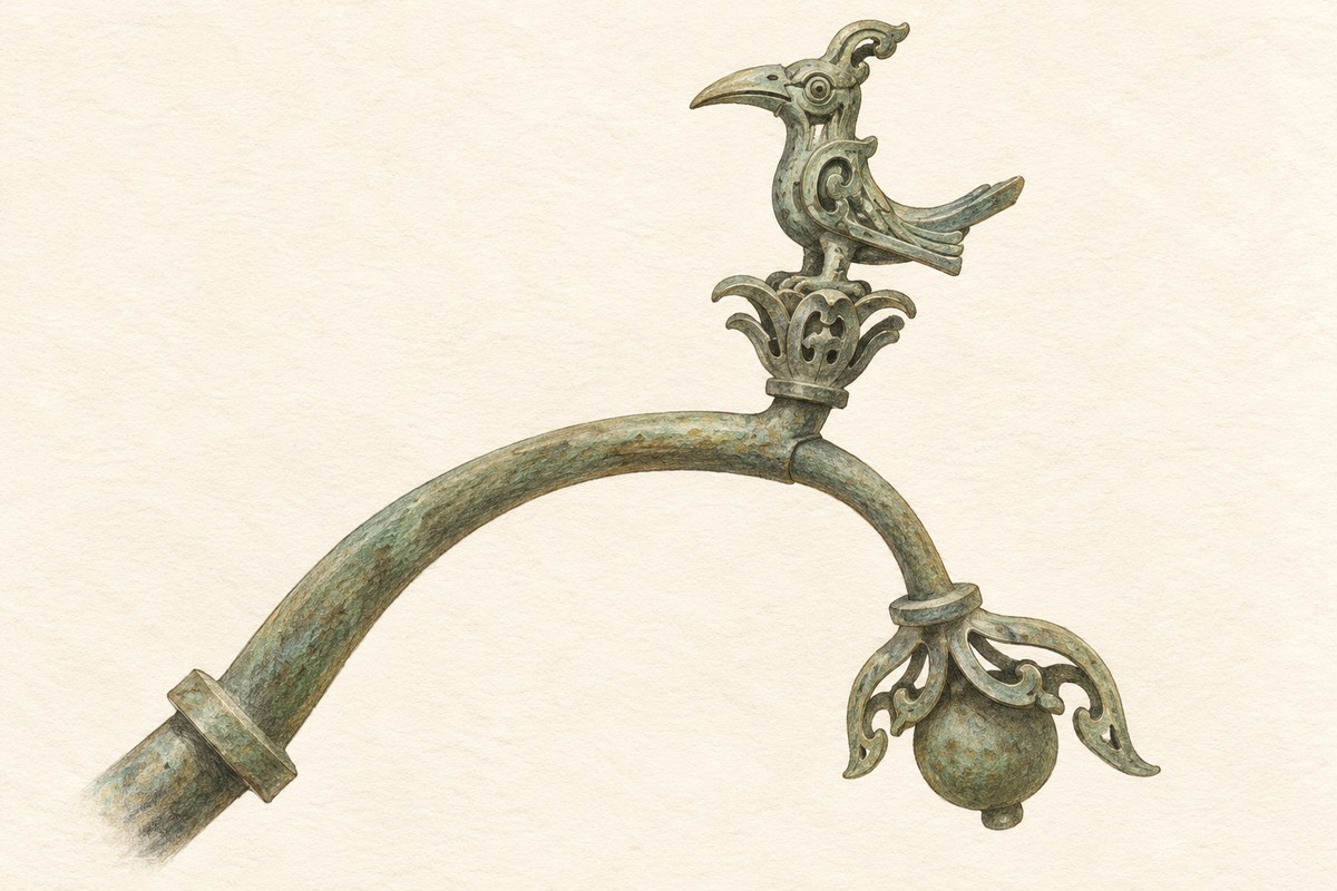 An illustrated crested bronze bird above a curved branch with a hanging fruit form.